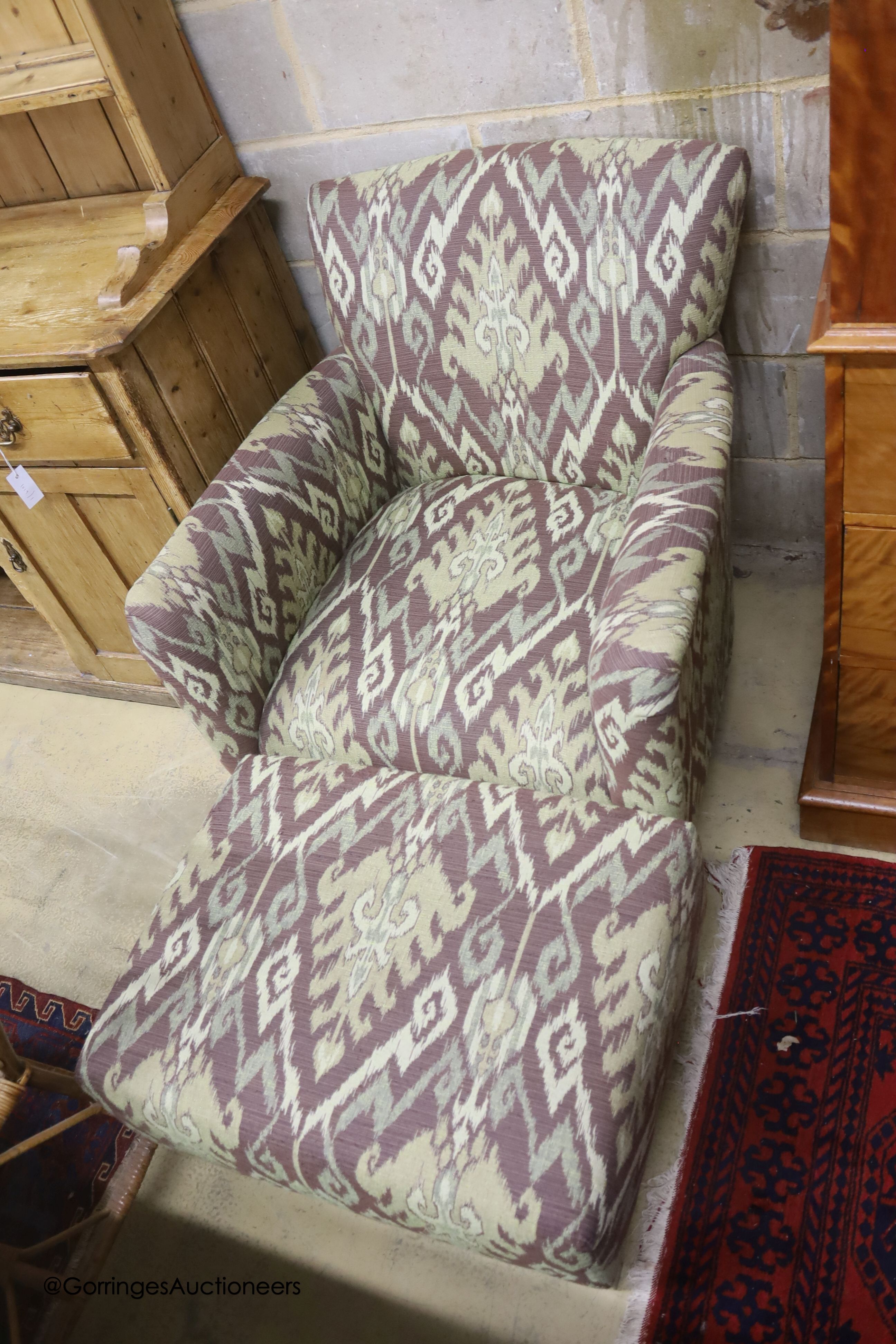 A Kelim upholstered armchair and matching footstool